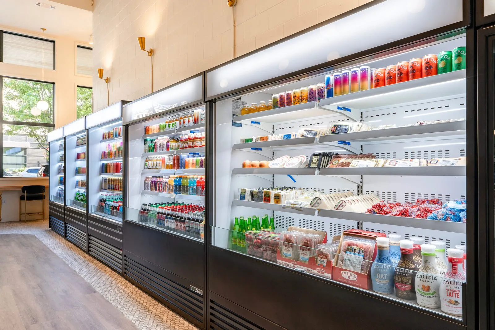The market's drink and grab-and-go coolers inside Le Marché Bleu